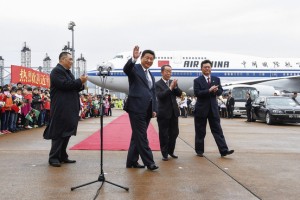 Chinese President Xi Jinping, center, waves to onlookers during a recent trip to Macau