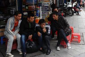 Men read news from a smartphone in downtown Hanoi, Vietnam [Image courtesy of WSJ]